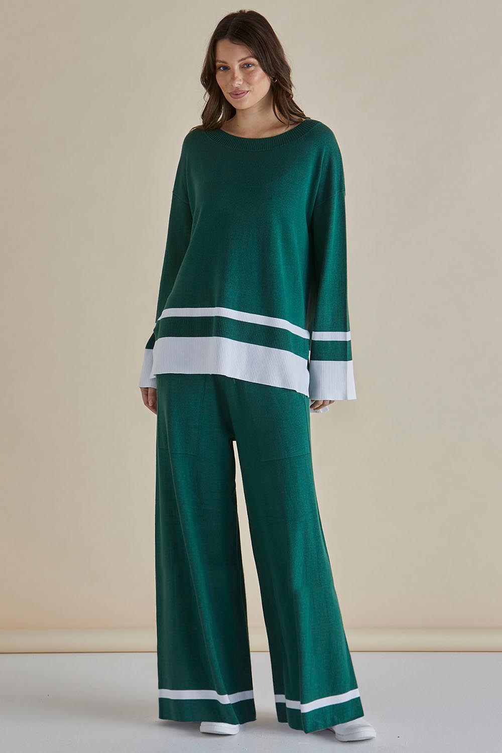 A model wearing the Delphine Knit Pant in colour Basil (Green), from the front, showing the whole outfit