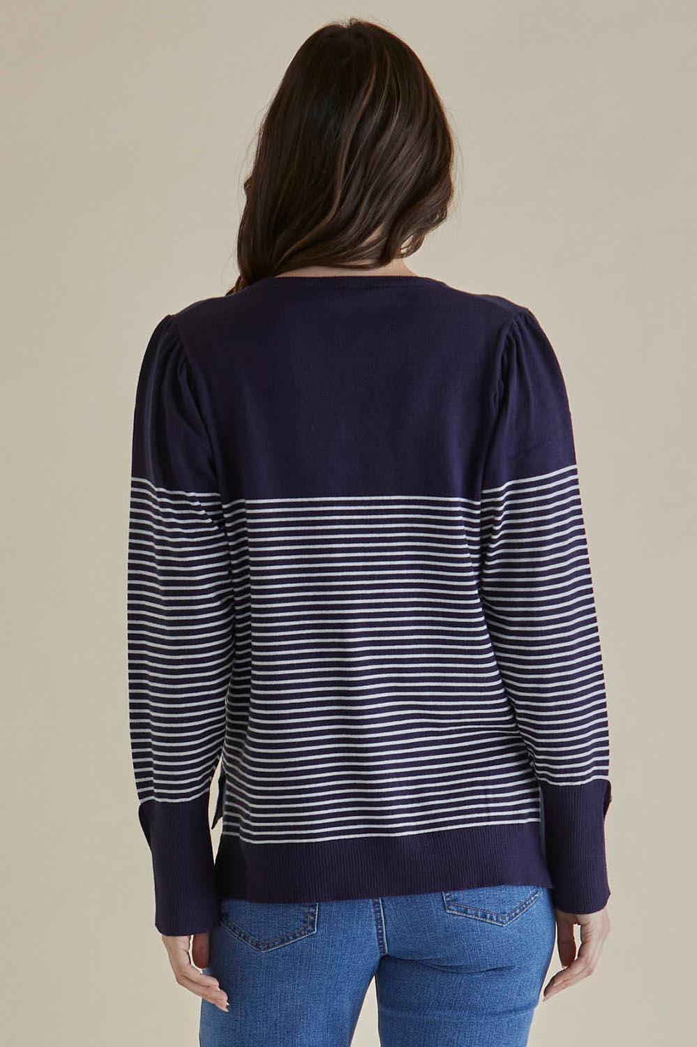A model wearing the Colette Sweater in colour Bluecream (Blue), from the back