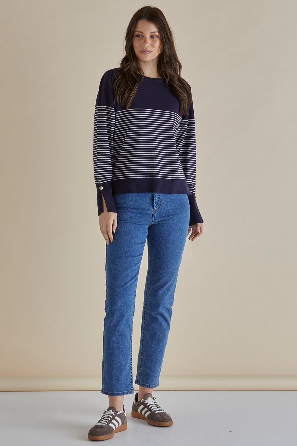 A model wearing the Colette Sweater in colour Bluecream (Blue), from the front, showing the whole outfit