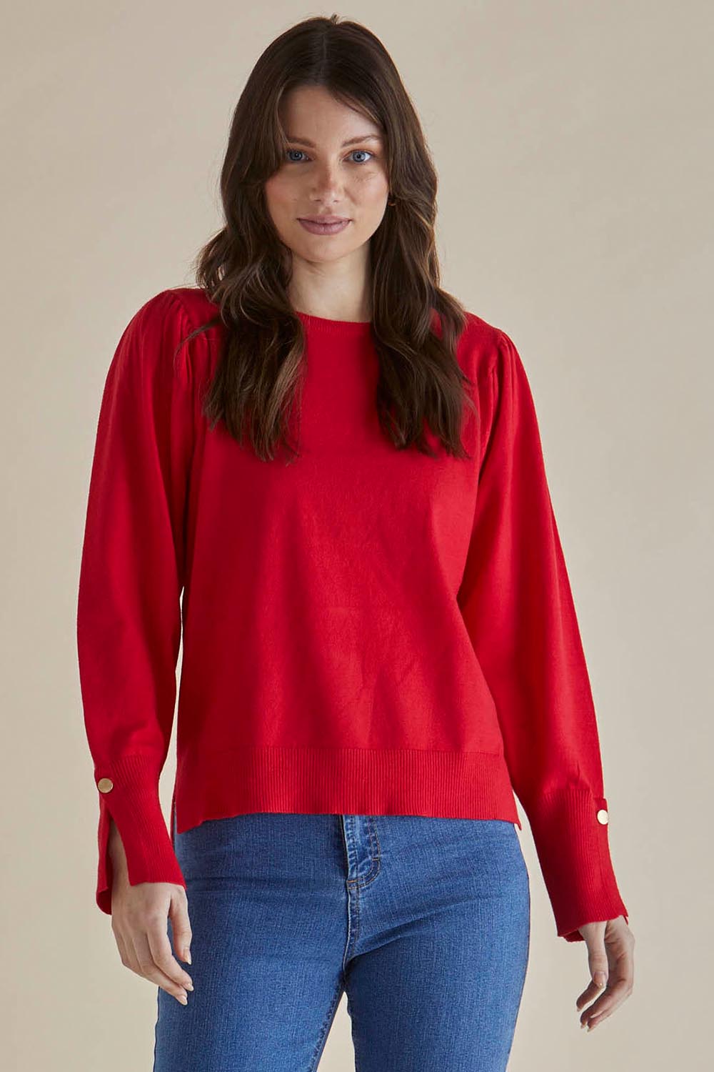 A model wearing the Colette Sweater in colour Red (Red), from the front, cropped image