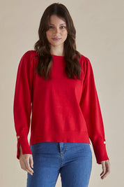 A model wearing the Colette Sweater in colour Red (Red), from the front, cropped image
