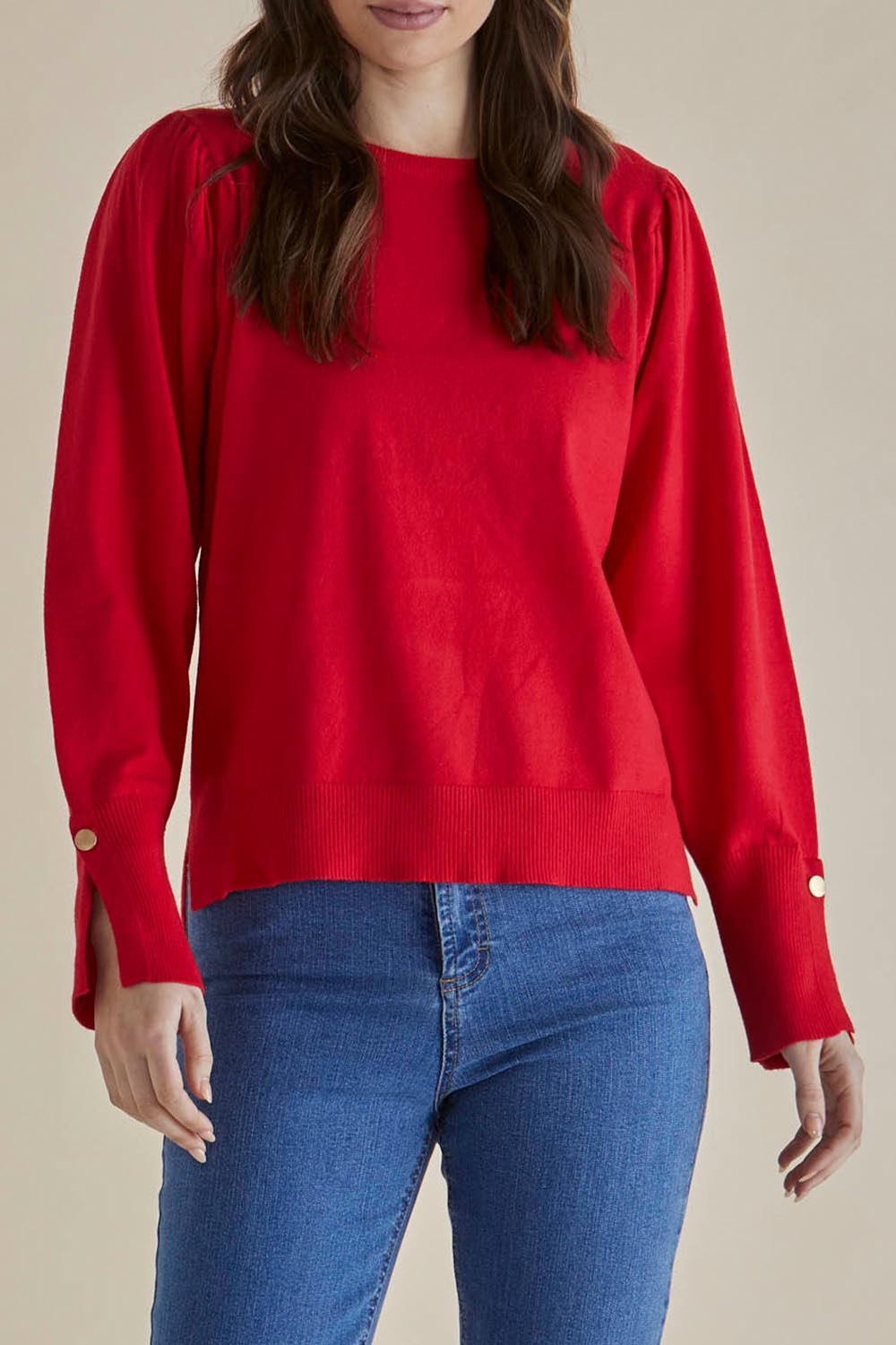 A model wearing the Colette Sweater in colour Red (Red), from the front, cropped image