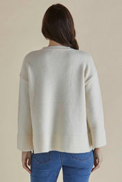 A model wearing the Edith Knit Jumper in colour Cream (White), from the back