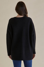 A model wearing the Emy Cardigan in colour Black (Black), from the back