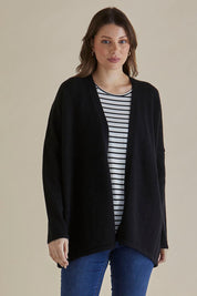 A model wearing the Emy Cardigan in colour Black (Black), from the front, cropped image