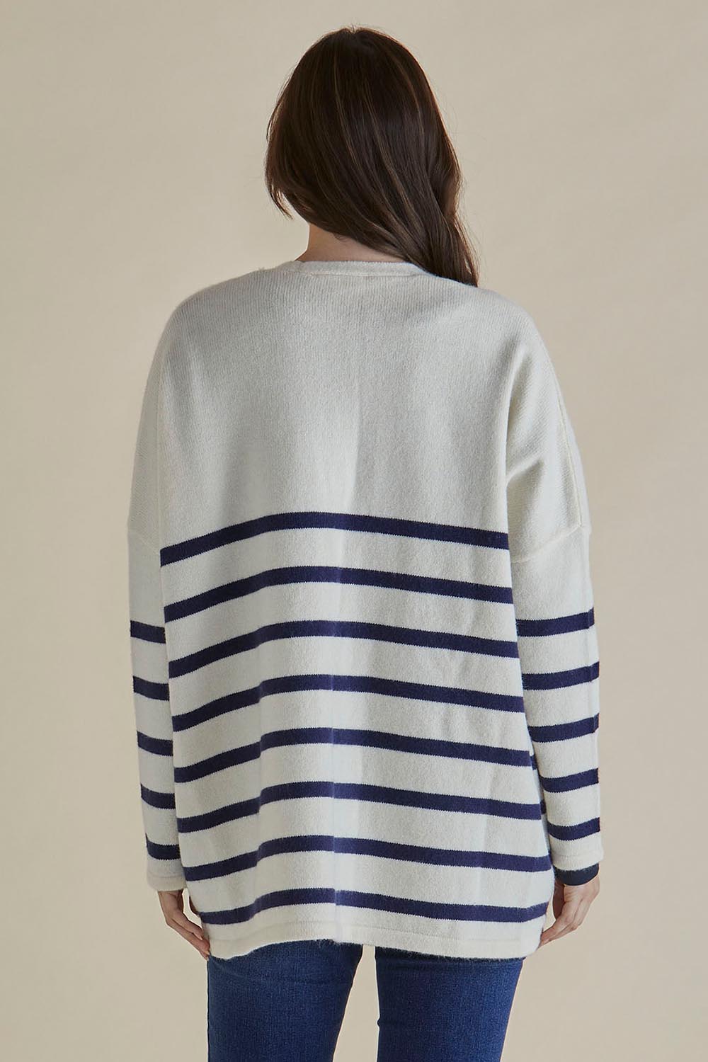 A model wearing the Emy Cardigan in colour Bluestripe (Blue), from the back