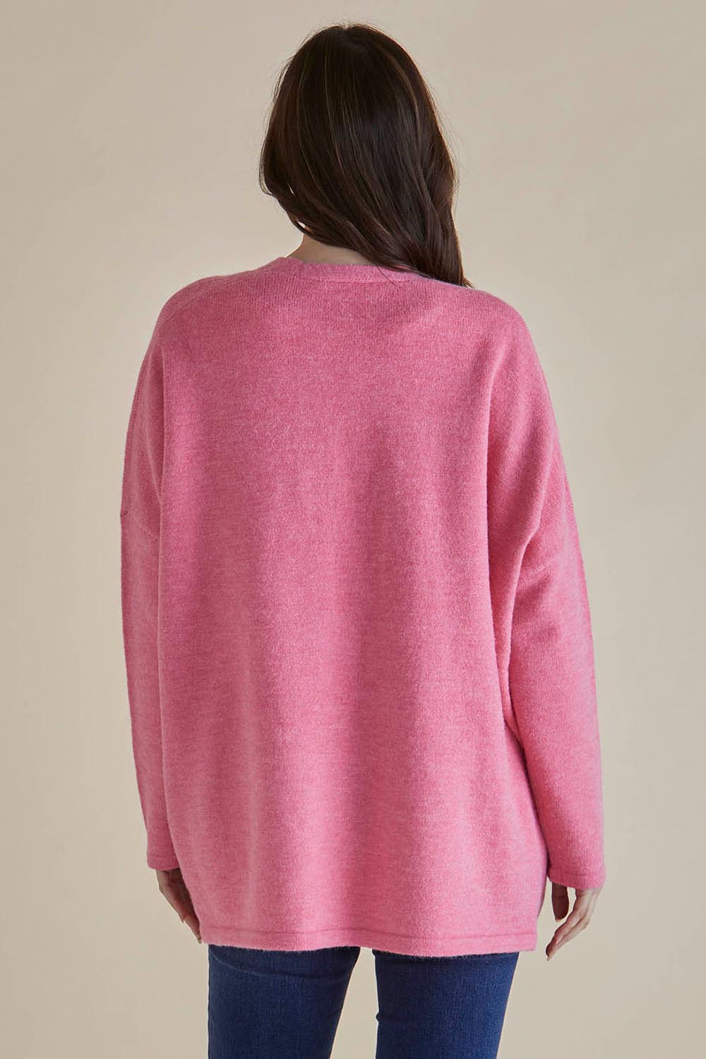 A model wearing the Emy Cardigan in colour Peonypink (Pink), from the back