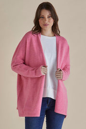 A model wearing the Emy Cardigan in colour Peonypink (Pink), from the front, cropped image