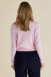 A model wearing the Cable Mini Jumper in colour Babypink (Pink), from the back