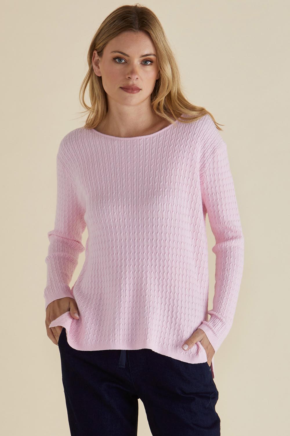 A model wearing the Cable Mini Jumper in colour Babypink (Pink), from the front, cropped image
