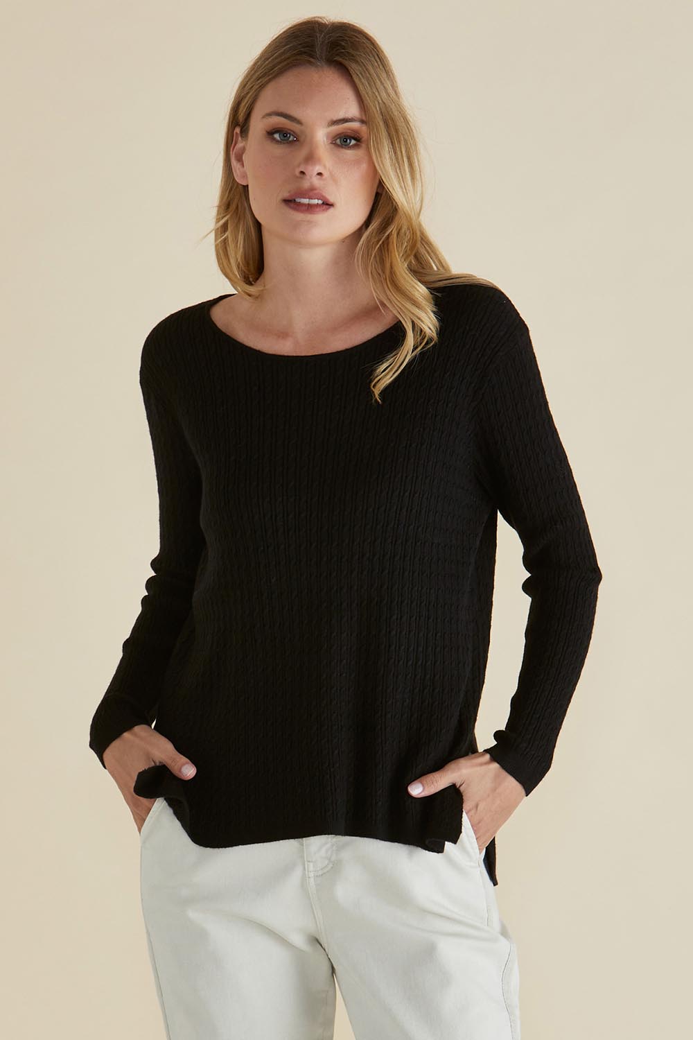 A model wearing the Cable Mini Jumper in colour Black (Black), from the front, cropped image