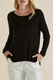 A model wearing the Cable Mini Jumper in colour Black (Black), from the front, cropped image