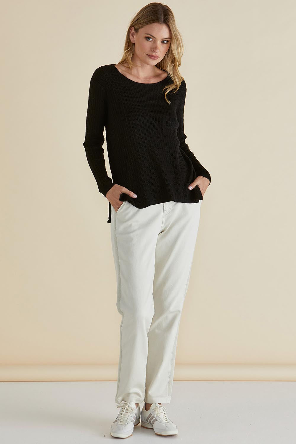 A model wearing the Cable Mini Jumper in colour Black (Black), from the front, showing the whole outfit