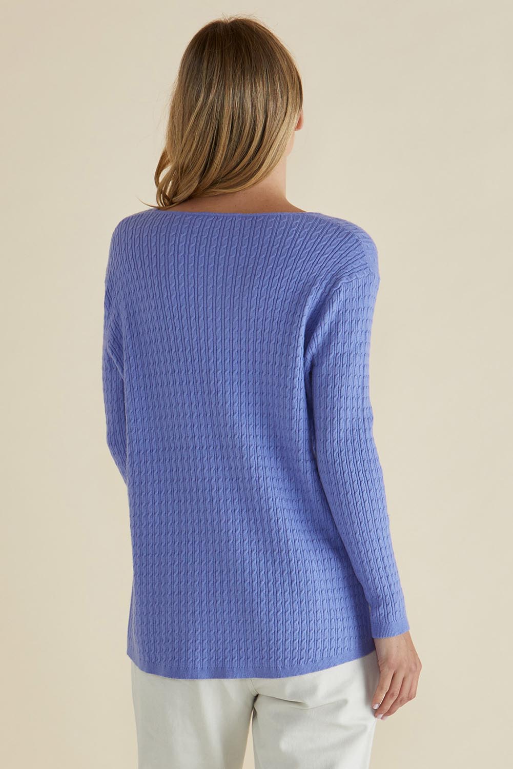 A model wearing the Cable Mini Jumper in colour Powderblue (Blue), from the back