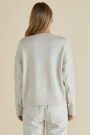 A model wearing the Celene Knit Cardigan in colour Cream, from the back