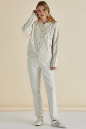 A model wearing the Celene Knit Cardigan in colour Cream, from the front, showing the whole outfit