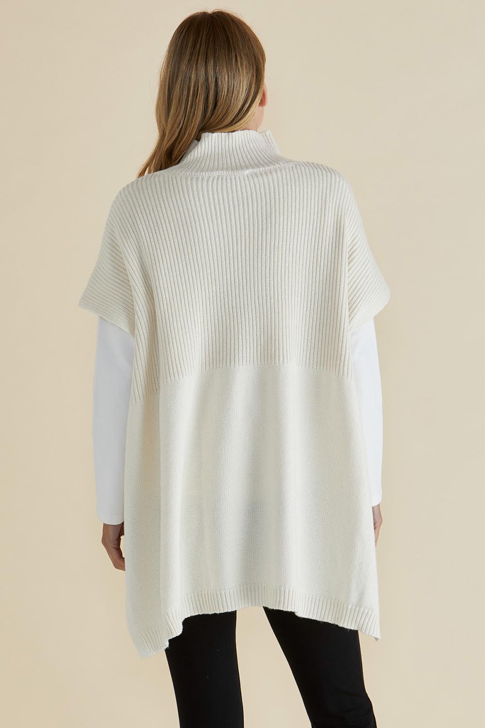 A model wearing the Paige Cotton Blend Poncho in colour Oat, from the back