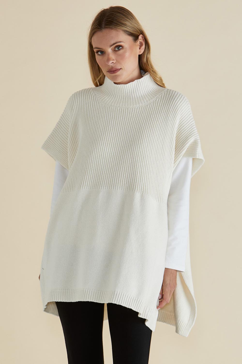 A model wearing the Paige Cotton Blend Poncho in colour Oat, from the front, cropped image