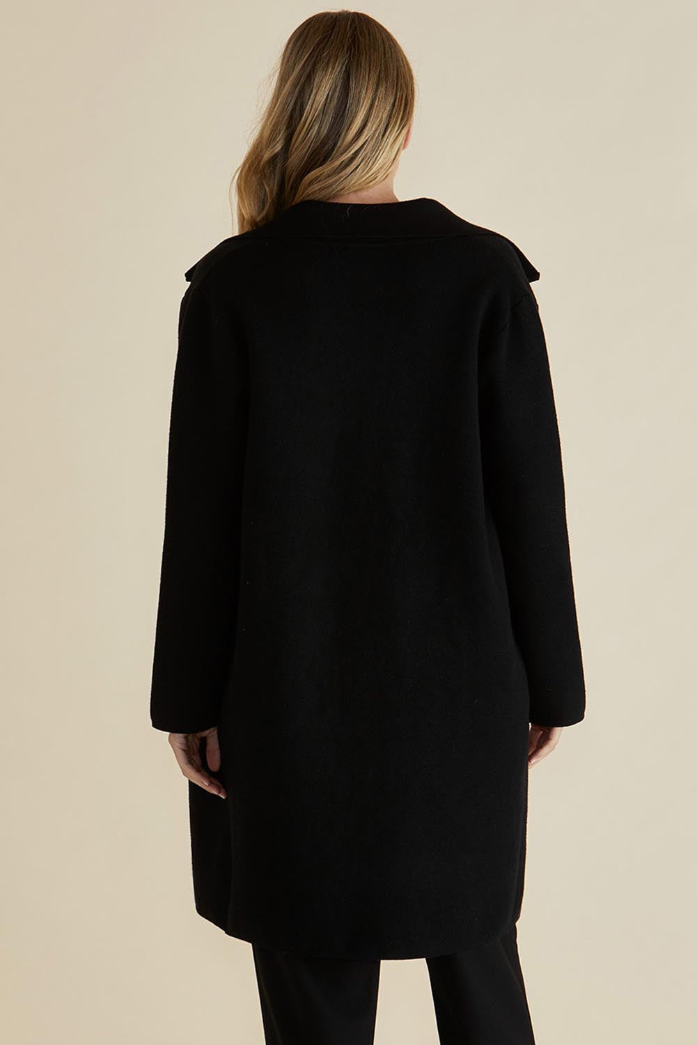 A model wearing the Cosette Jacket in colour Black (Black), from the back