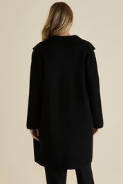 A model wearing the Cosette Jacket in colour Black (Black), from the back