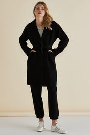 A model wearing the Cosette Jacket in colour Black (Black), from the front, showing the whole outfit