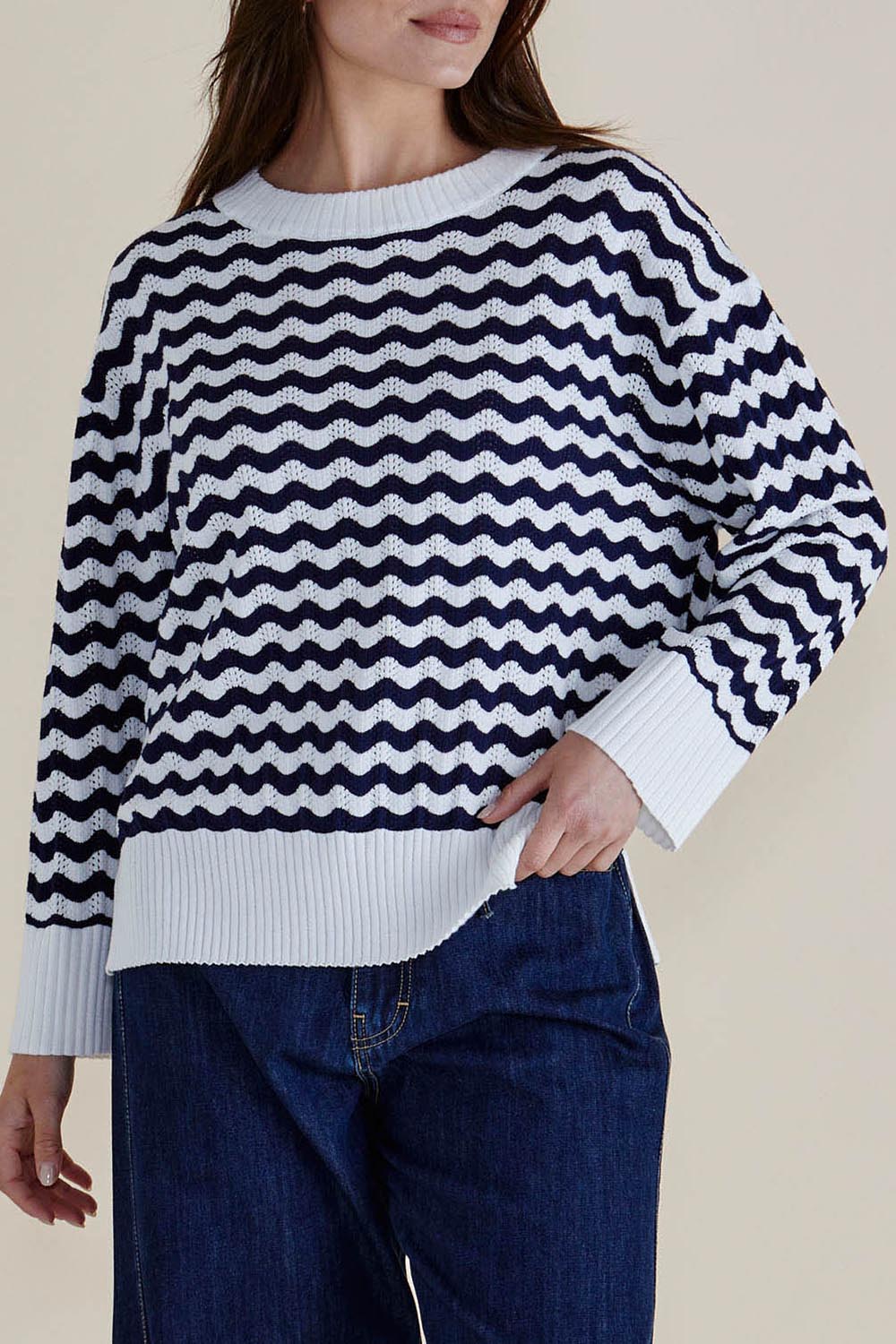 A model wearing the Ember Cotton Knit Jumper in colour Navywave (Blue), from the front, cropped image