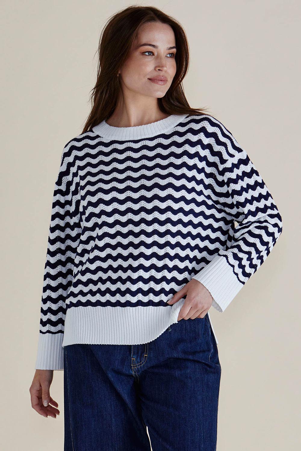 A model wearing the Ember Cotton Knit Jumper in colour Navywave (Blue), from the front, cropped image