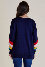 A model wearing the Mimi Sweater in colour Rainbow (Blue), from the back
