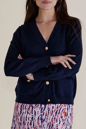 A model wearing the Leon Cotton Blend Knit Cardigan in colour Navy (Blue), from the front, cropped image