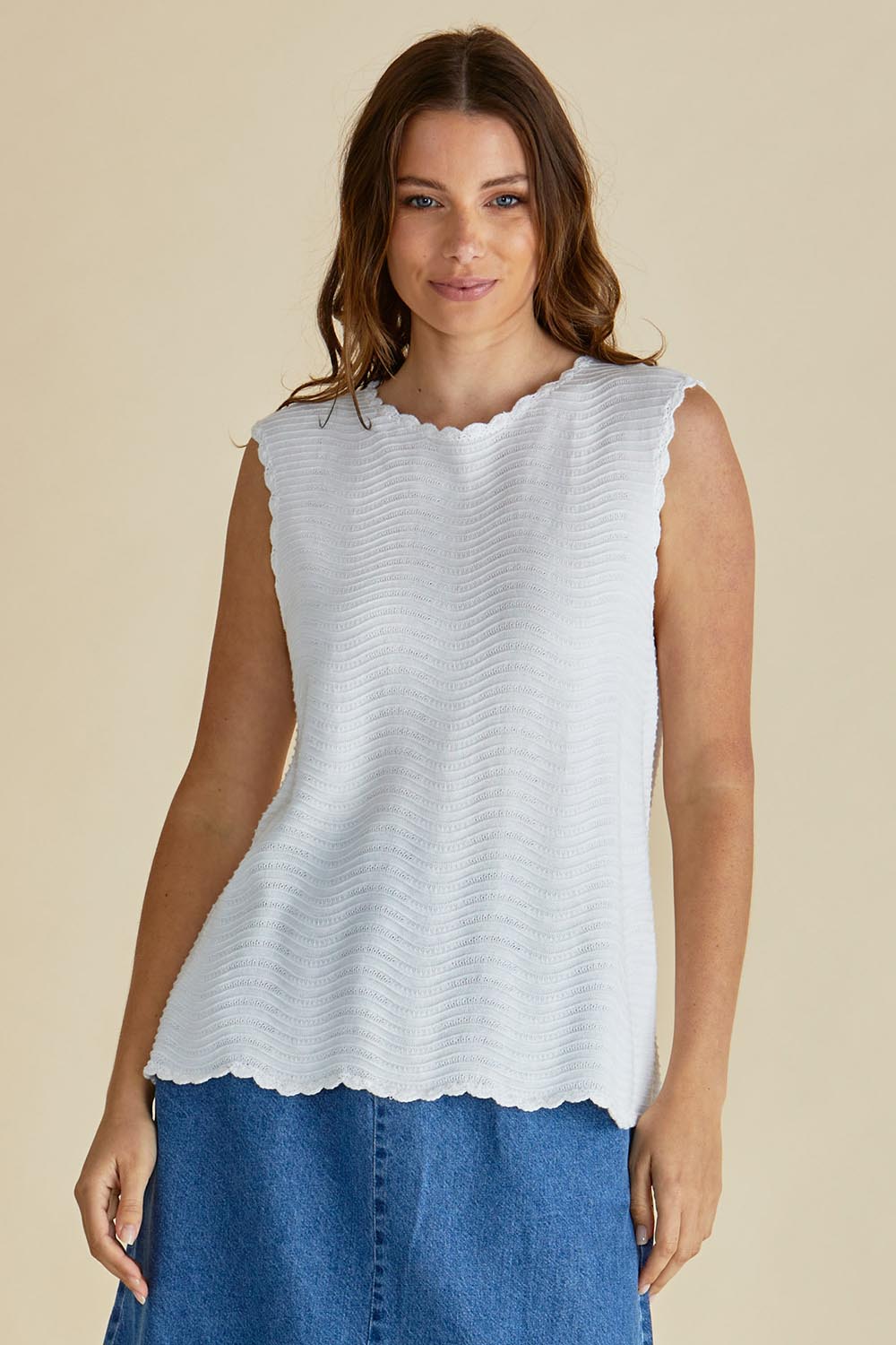 A model wearing the Aviva Cotton Tank in colour White (White), from the front, cropped image