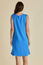 A model wearing the Viola Cotton Tank Dress in colour Blue (Blue), from the back