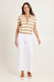 Model Madeline wearing size 10 of the Salford Cotton Knit Polo in colour Beige, from the front, showing the whole outfit