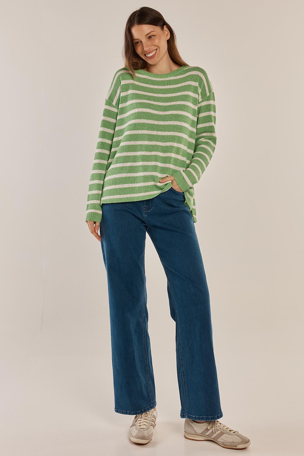 A model wearing the Bradford Knit Top in colour Greencream (Green), from the front, showing the whole outfit