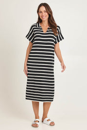Model Madeline wearing size 10 of the Bradford Knit Polo Dress in colour Creamblk (Black), from the front, showing the whole outfit