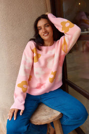 A model wearing the Leonie Knit Sweater in colour Flowers (Pink), from the front, showing the whole outfit
