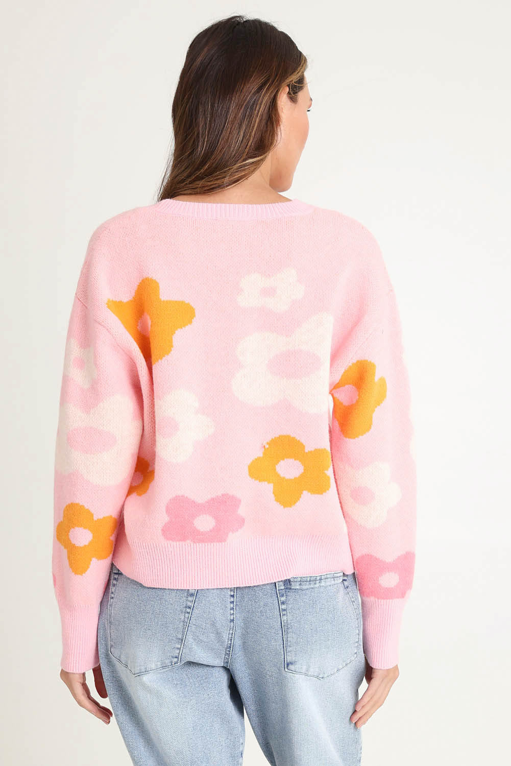 Model Madeline wearing size 10 of the Leonie Knit Sweater in colour Flowers (Pink), from the back