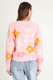 Model Madeline wearing size 10 of the Leonie Knit Sweater in colour Flowers (Pink), from the back