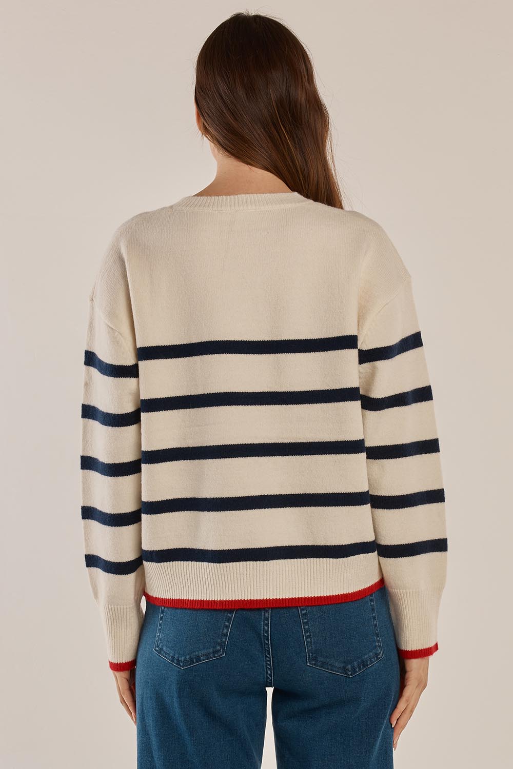 A model wearing the Leonie Knit Sweater in colour Navywhite (White), from the back