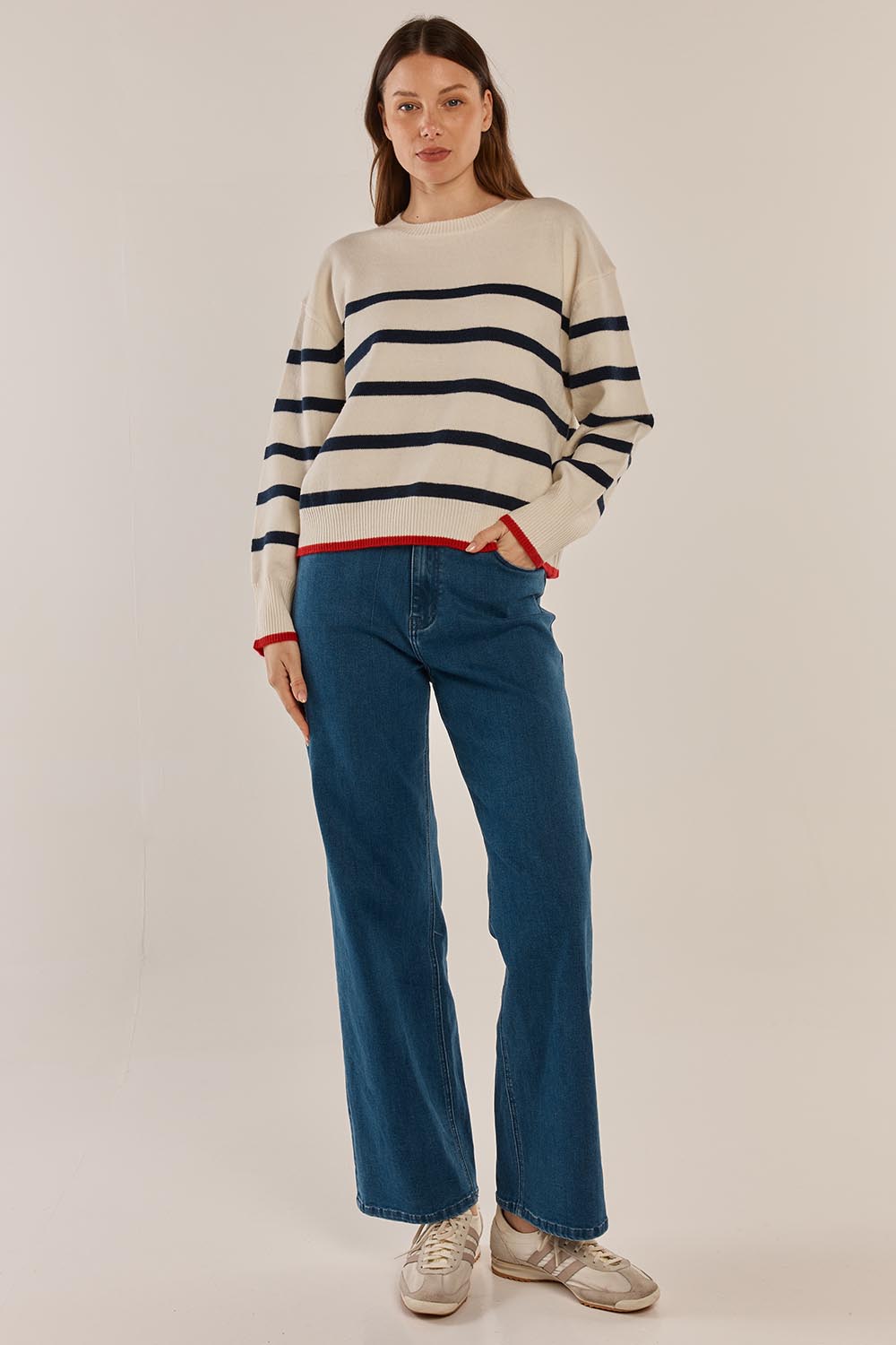 A model wearing the Leonie Knit Sweater in colour Navywhite (White), from the front, showing the whole outfit