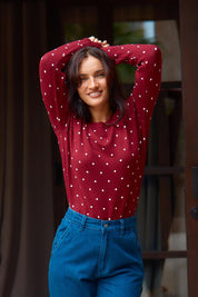 A model wearing the Louis Sweater in colour Burgandy (Red), from the front, showing the whole outfit