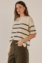A model wearing the Bailey Boxy Sweater in colour Cream, from the front, cropped image