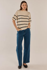 A model wearing the Bailey Boxy Sweater in colour Cream, from the front, showing the whole outfit