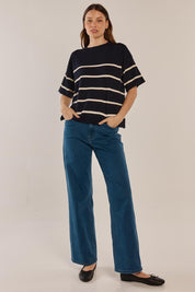 A model wearing the Bailey Boxy Sweater in colour Navy (Blue), from the front, showing the whole outfit
