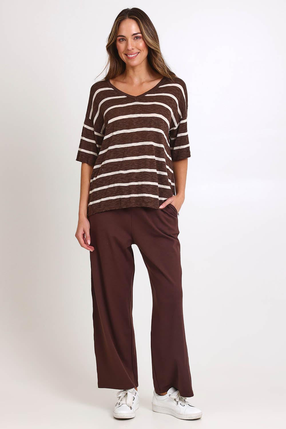 Model Madelinec wearing size 10 of the Aries V-Neck Sweater Tee – Chocolate in colour Chocolate, from the front