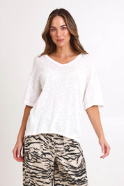 Model Madelinec wearing size 10 of the Aries V-Neck Sweater – White in colour White, in a cropped view