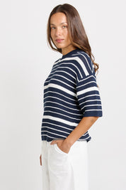 Model Genericm wearing size sample of the Dylan Knit Tee – Navywhite in colour Navywhite, from an angle