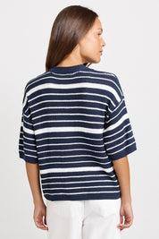 Model Genericm wearing size sample of the Dylan Knit Tee – Navywhite in colour Navywhite, from an angle
