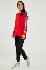 Model Katie wearing size 10 of the Amelia Knit in colour Raspberry (Red), from the front, showing the whole outfit