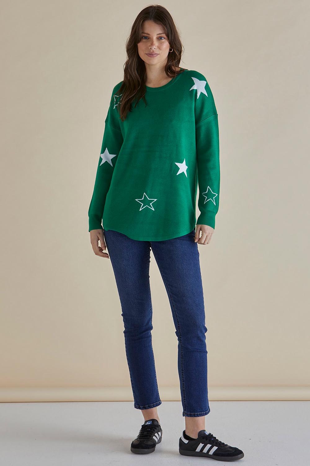 A model wearing the Sophie Knit Jumper in colour Greenstar (Green), from the front, showing the whole outfit