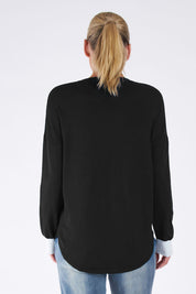 A model wearing the Sophie Knit Jumper in colour Blackstar (Black), from the back